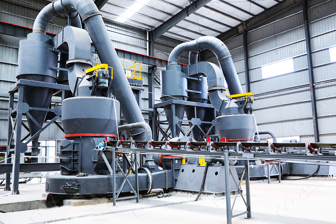 Aerial view of a modern industrial grinding plant with storage silos and processing buildings in India.