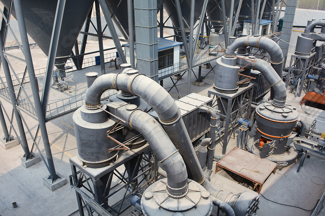 Close-up view of an automated touchscreen control panel for monitoring and adjusting grinding mill parameters.