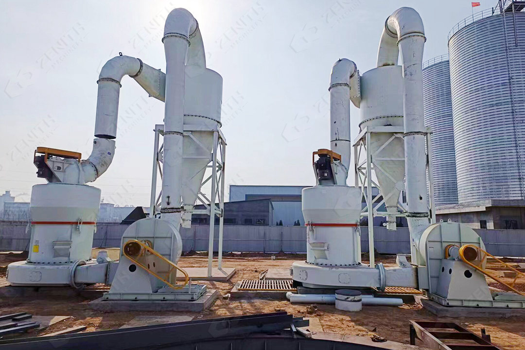 A network of large cyclone powder collectors and ducting in a grinding plant, with clean, white barite powder visible in collection bins.