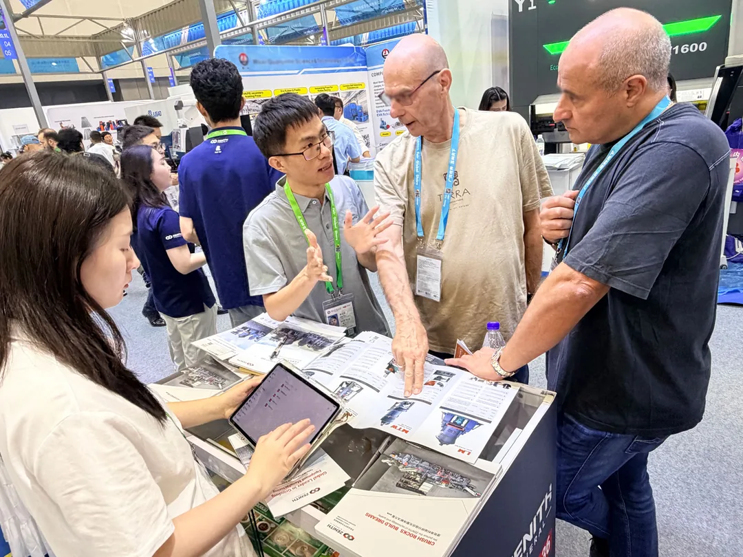 ZENITH engineer discussing a grinding solution with two European buyers