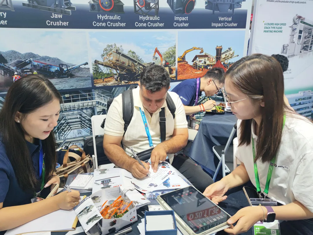 Buyer filling in a project specification sheet at the ZENITH booth