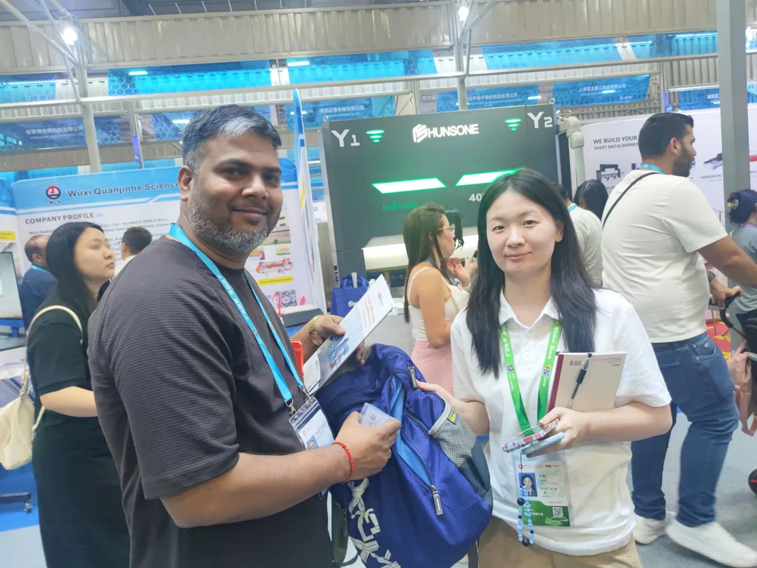 ZENITH staff talking to a buyer in the aisle at the 140th Canton Fair