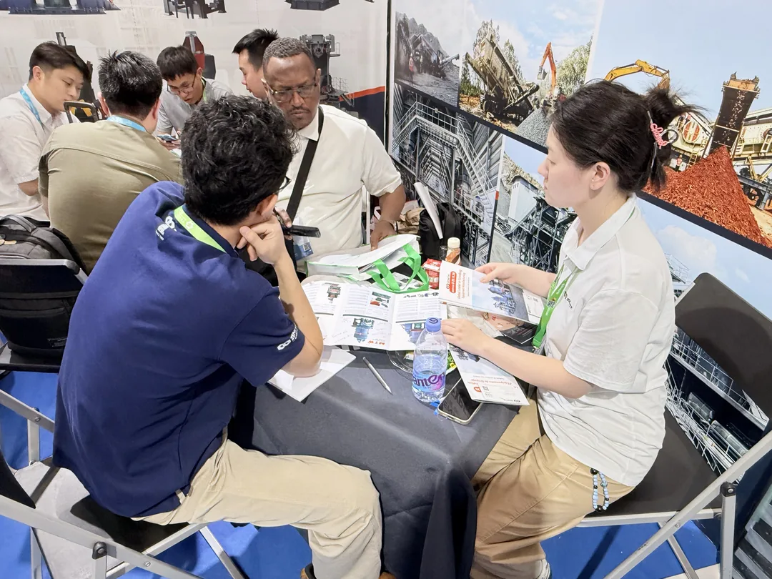 ZENITH team discussing grinding mill selection with visitors at the booth