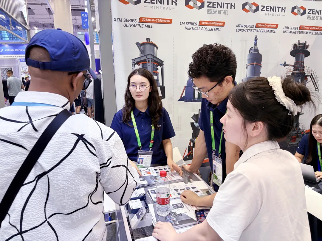 ZENITH engineer answering questions in front of the grinding mill product wall