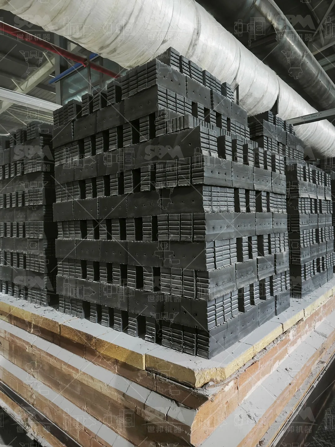 Pressed green bodies stacked on kiln cars before entering the tunnel kiln