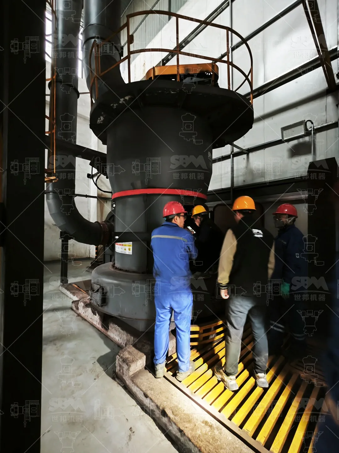 Service engineer and plant staff checking the mill during the follow-up visit