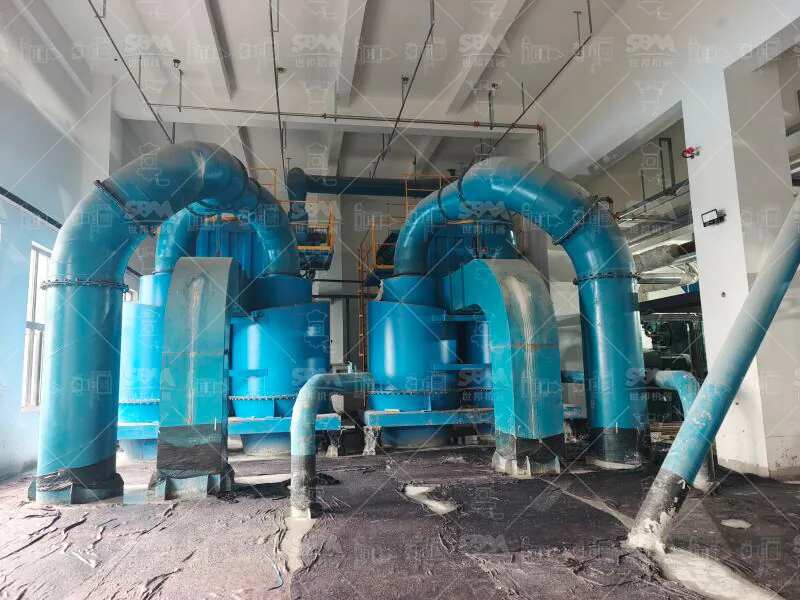 Finished calcined petroleum coke powder at the discharge area of the grinding line